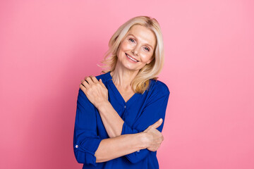 Poster - Photo portrait of lovely pensioner lady hugging self dressed stylish blue garment isolated on pink color background