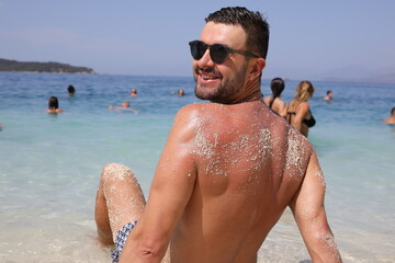 Attractive bearded shirtless man at the beach 