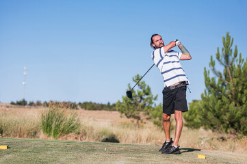 young man playing golf