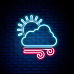 Canvas Print - Glowing neon line Windy weather icon isolated on brick wall background. Cloud with sun and wind. Colorful outline concept. Vector