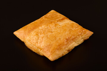 (Merdenea) pie with cheese on a table on a black background.