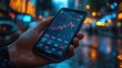 © The prominence - Close-up of hands holding a smartphone showing stock trading performance