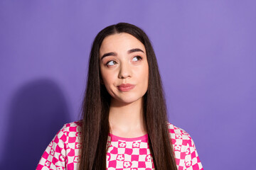 Portrait of nice young woman look empty space think wear checkered t-shirt isolated on violet color background