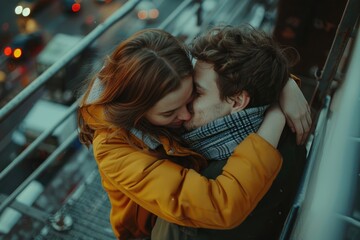 Canvas Print - A couple is kissing on a ledge. The man is wearing a yellow jacket. The woman is wearing a scarf