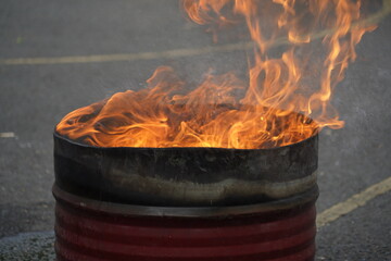 fire burning red inside the drum