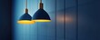 © Aris Suwanmalee - Modern pendant lamps illuminate a serene blue wall, creating a stylish ambiance perfect for contemporary interiors.