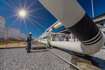 Poster - Male worker inspection at steel long pipes and pipe elbow in station oil factory during refinery valve of visual check record pipeline oil