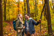 © Zoran Zeremski - Smiling couple with backpacks hiking together in forest.