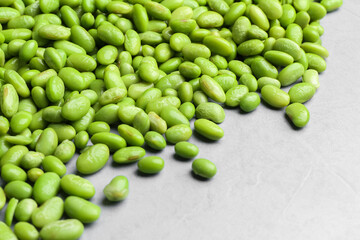 Wall Mural - Fresh edamame soybeans on grey textured table, closeup