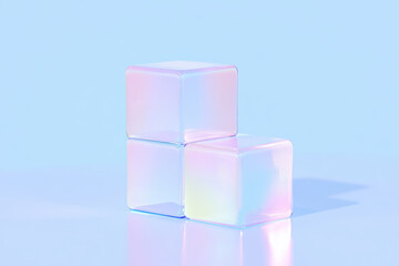 Poster - Three translucent iridescent cubes stacked on a smooth blue surface with soft reflections and gentle lighting.