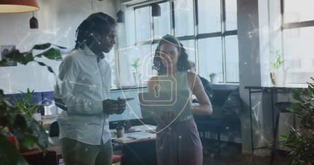 Canvas Print - Image of shapes and padlock over diverse business people discussing work