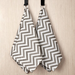 Wall Mural - cotton waffle towels for the kitchen hang on hooks on a bracket against a white wall background