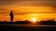 © Supriyanto - A golfer stands silhouetted against a vibrant sunset on a golf course.