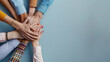 © khonkangrua - Close-up of diverse hands stacked together, representing teamwork, unity, and collaboration among people of different backgrounds.