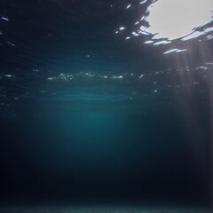 dark blue ocean surface seen from underwater with sunrays