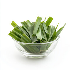 fresh pandan leaves are arranged neatly in clear glass bowl, showcasing their vibrant green color an