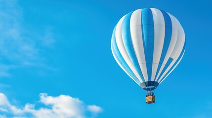 A vibrant hot air balloon rises gracefully against a bright blue sky, surrounded by fluffy white clouds, marking a perfect day for ballooning adventures