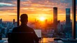 © Sasint - A sunrise seen through an office window, with a person already at their desk, ready to start the day with focus