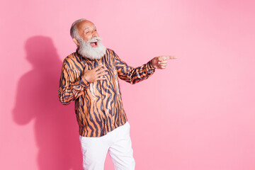 Wall Mural - Photo of funny grandfather laugh point finger empty space tiger print shirt isolated on pink color background