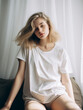 © Alena - Cheerful young woman in white t-shirt