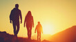 © Vertigo Images - Silhouettes of a family walking into the sunset.