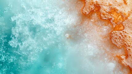  A birds-eye perspective of a body of water exhibiting orange and blue foam at its surface