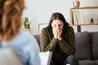 © peopleimages.com - Stress, psychologist and talking to woman patient on sofa for medical support, depression risk and trauma. Counseling, doctor and consultation for mental health and victim with ptsd, fear and anxiety