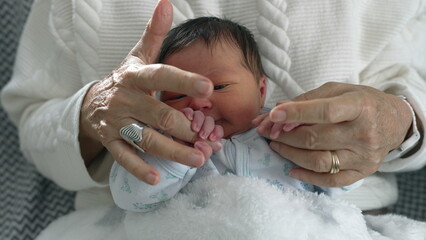 Newborn cradled in grandmother’s arms, smiling softly, creating a heartwarming moment of joy and love within a comforting family setting, showcasing the bond between young and old