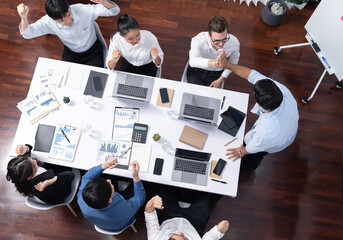 Canvas Print - Top view diverse office employee worker high five after making agreement on strategic business marketing planning. Teamwork and positive attitude create productive and supportive workplace. Prudent