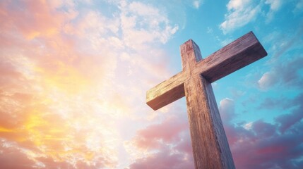 The silhouette of a wooden cross is highlighted by a vibrant sunset with mixed colors in the sky