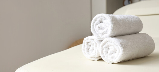 Canvas Print - Clean soft towels on white couch, closeup