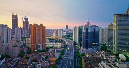 Wall Mural - Aerial shot of modern city road viaduct and buildings at sunrise in Shanghai