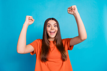 Sticker - Photo portrait of lovely teen lady celebrate winning dressed stylish orange garment isolated on blue color background