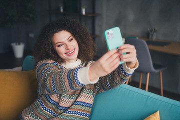 Wall Mural - Photo of lovely cute woman sitting sofa recording video in cozy living room indoors