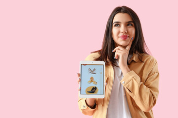 Canvas Print - Thoughtful young woman with tablet computer on pink background. Online shopping