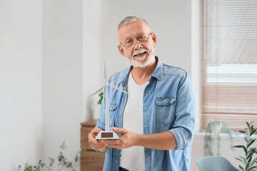 Sticker - Mature engineer with wind turbine model in office