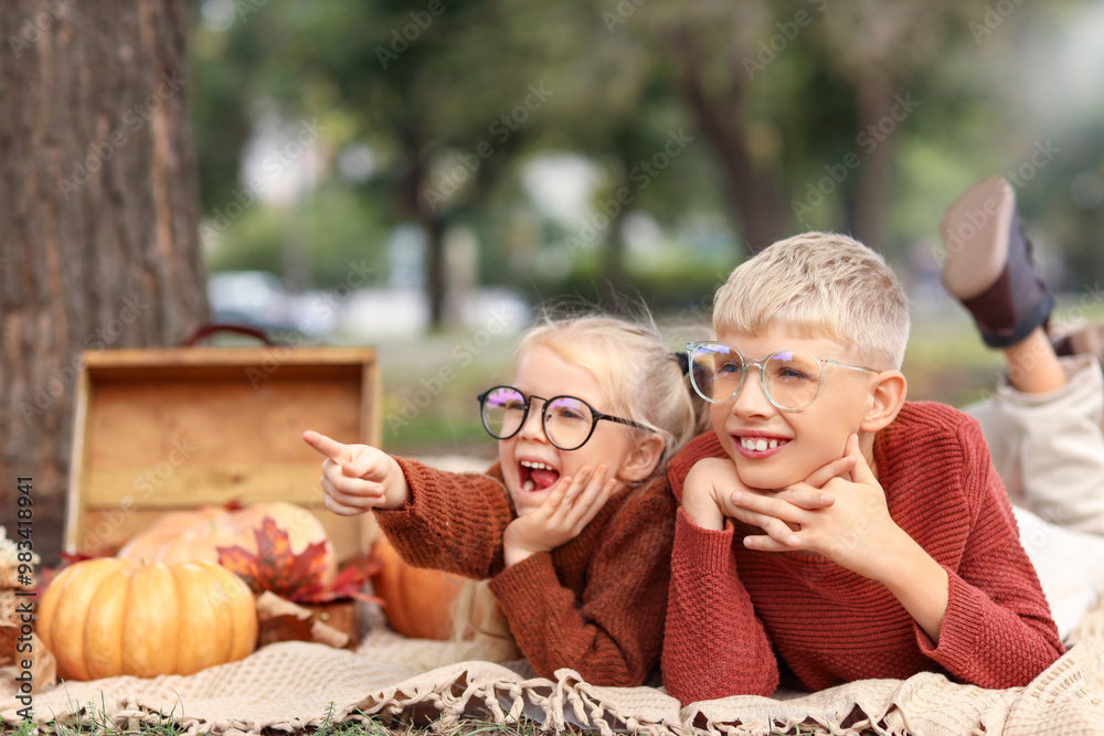 Happy children pointing at something on picnic in park