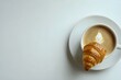 © diyana - A cup of coffee and a croissant  with a clean white table top. Good copy space for text