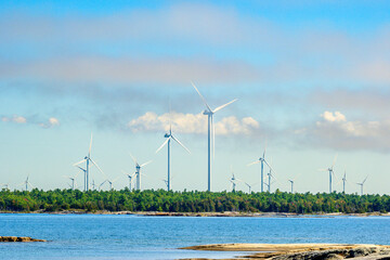 green economy: wind turbines on georgian bay ontario in summer room for text