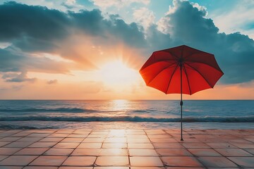 Canvas Print - Red umbrella on beach at sunset with colorful clouds and ocean waves