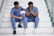 © peopleimages.com - Men, doctors and comfort with stress at hospital for medical mistake, depression and healthcare burnout. People, consoling and stairs with surgery news, mental health anxiety and emergency crisis
