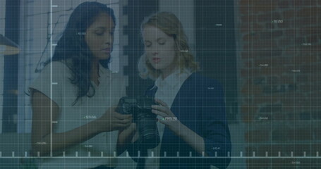 Poster - Analyzing camera settings, two women over stock market data image