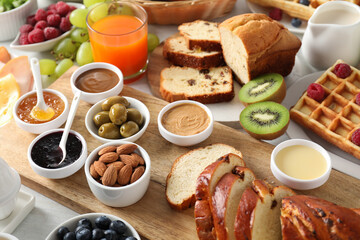 Wall Mural - Different meals served for breakfast on white table, closeup. Buffet menu