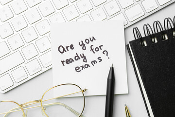 Sticker - Paper note with question Are You Ready For Exams and stationery on grey background, flat lay