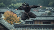 © Andres Mejia - Ninja warrior jumping roofs in traditional japanese village