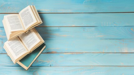 Wall Mural - Open Books on Blue Wooden Background