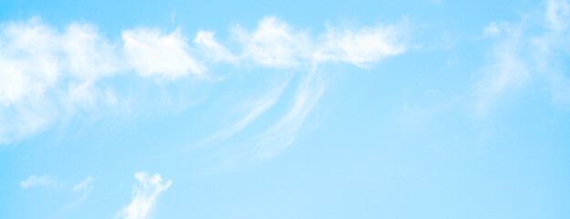 Wall Mural - clear blue sky with a few clouds. The sky is very bright and the clouds are scattered throughout