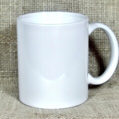 A plain white ceramic mug with a handle