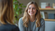 © Helena - Client and therapist sharing a light smile in calm professional office with natural light and warm atmosphere