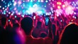 © BerkahStock - A crowd at a concert with colorful lights, capturing the moment on a smartphone.